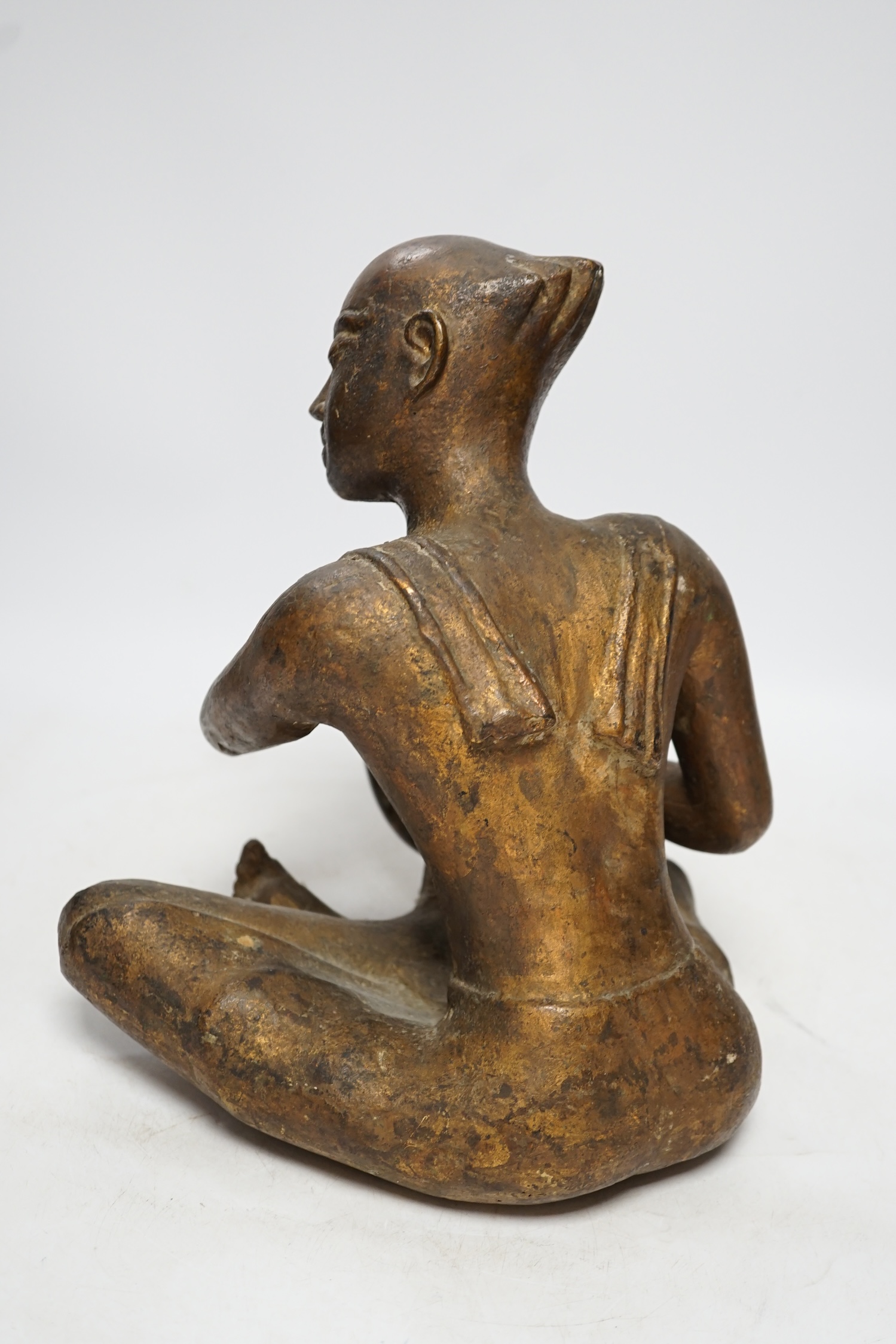 A South East Asian bronze and composition figure, 27cm high. Condition - fair